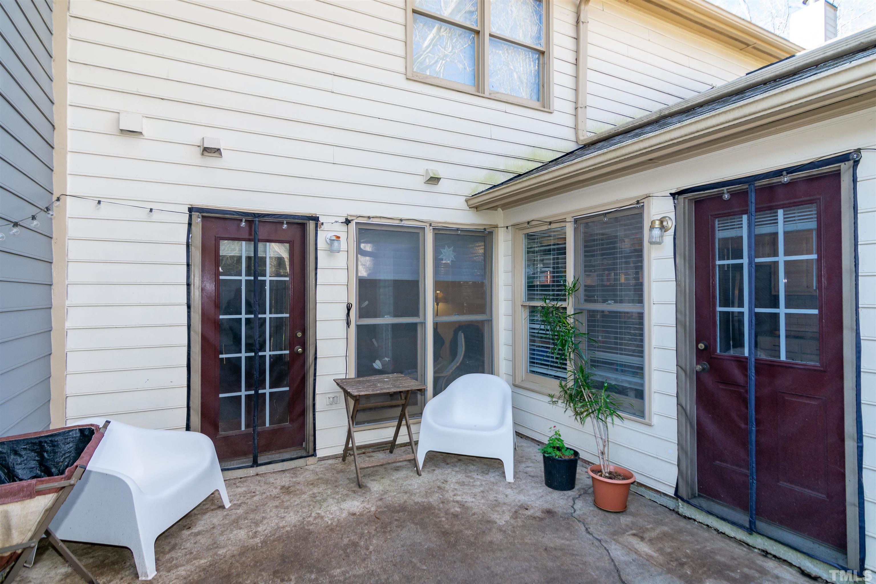 6722 Twin Tree Court Raleigh, NC 27613 - Photo 30 of 33 a view of a house with a chairs in a patio