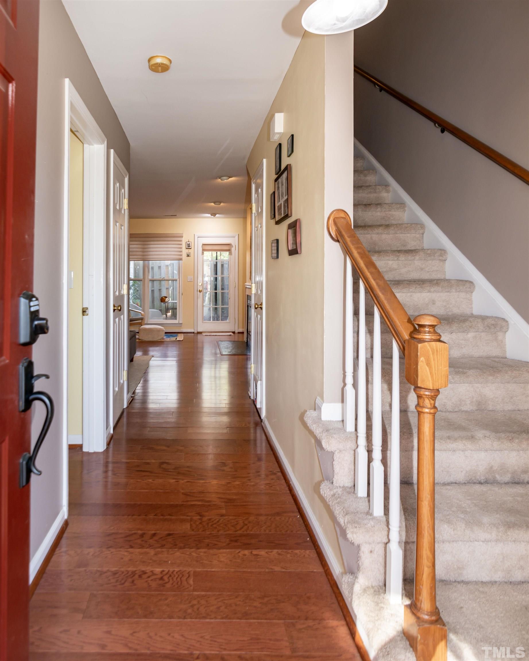 6722 Twin Tree Court Raleigh, NC 27613 - Photo 4 of 33 a view of a hallway with wooden floor and staircase