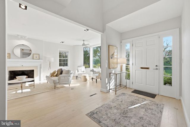 a living room with furniture large window and a fireplace