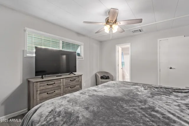 a bedroom with a bed and a flat screen tv