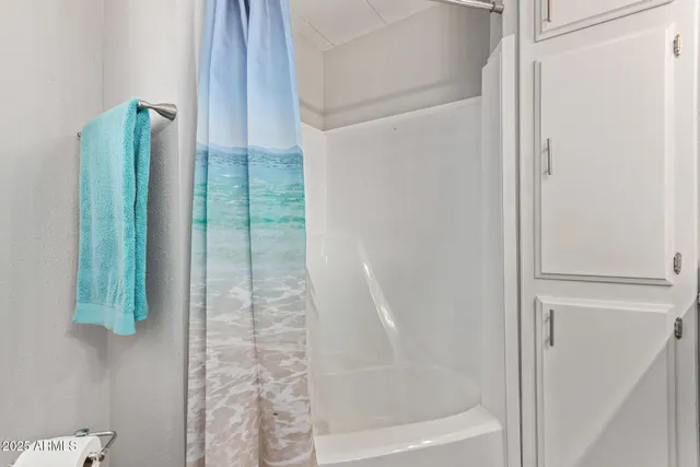 a bathroom with a bathtub and shower