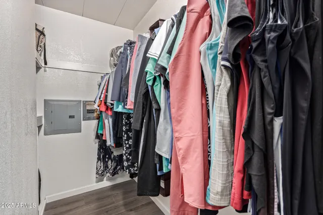 a view of walk in closet with clothes