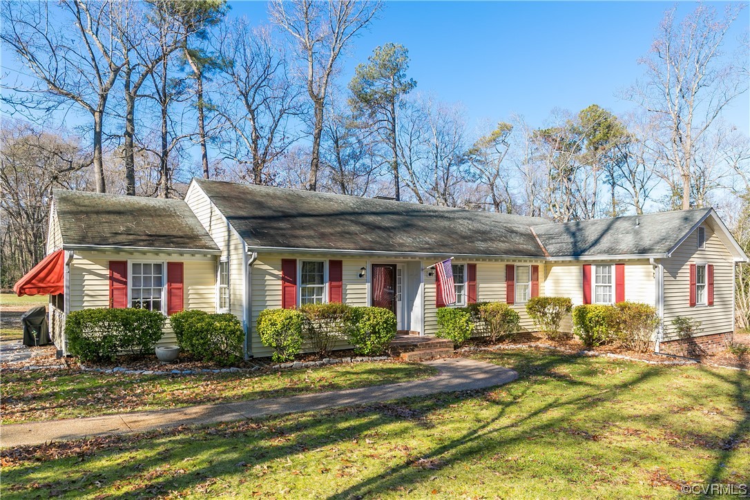 a front view of house with yard and green space