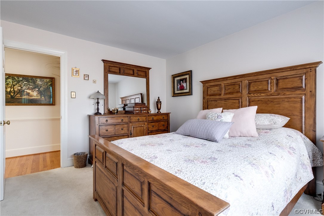 1430 Bloomfield Road Richmond, VA 23225 - Photo 16 of 47 a large bedroom with a bed and wooden floor