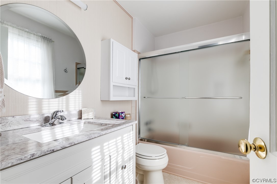 1430 Bloomfield Road Richmond, VA 23225 - Photo 18 of 47 a bathroom with a granite countertop sink mirror vanity and toilet