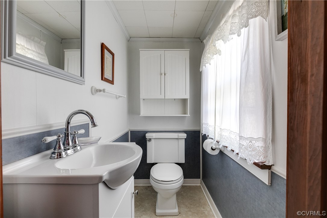1430 Bloomfield Road Richmond, VA 23225 - Photo 39 of 47 a bathroom with a toilet sink and mirror