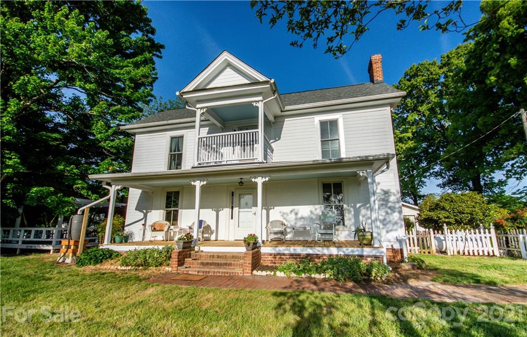 a view of a house with backyard porch and sitting area