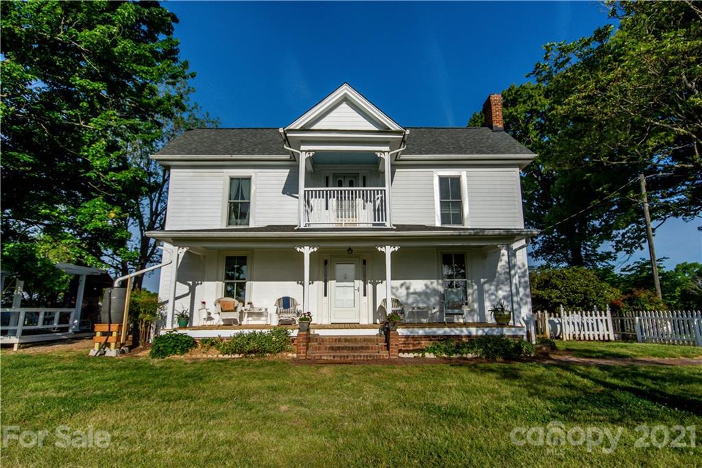 1870 Centenary Church Road Mount Ulla, NC 28125 - Photo 2 of 48 a front view of a house with a garden and trees