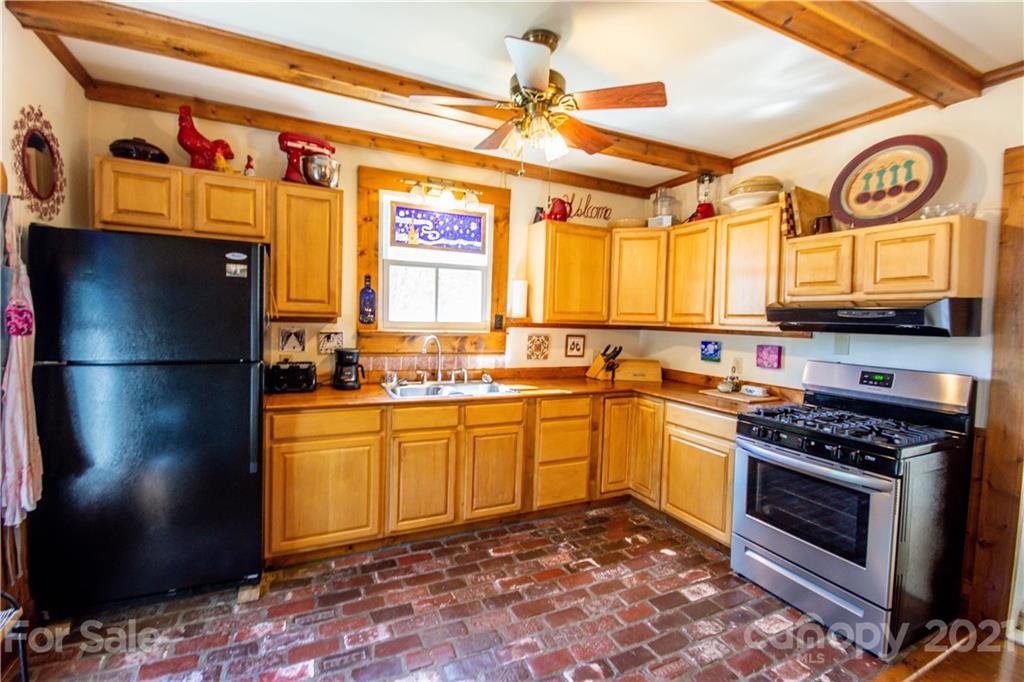 1870 Centenary Church Road Mount Ulla, NC 28125 - Photo 16 of 48 a kitchen with stainless steel appliances granite countertop a stove a sink and a refrigerator