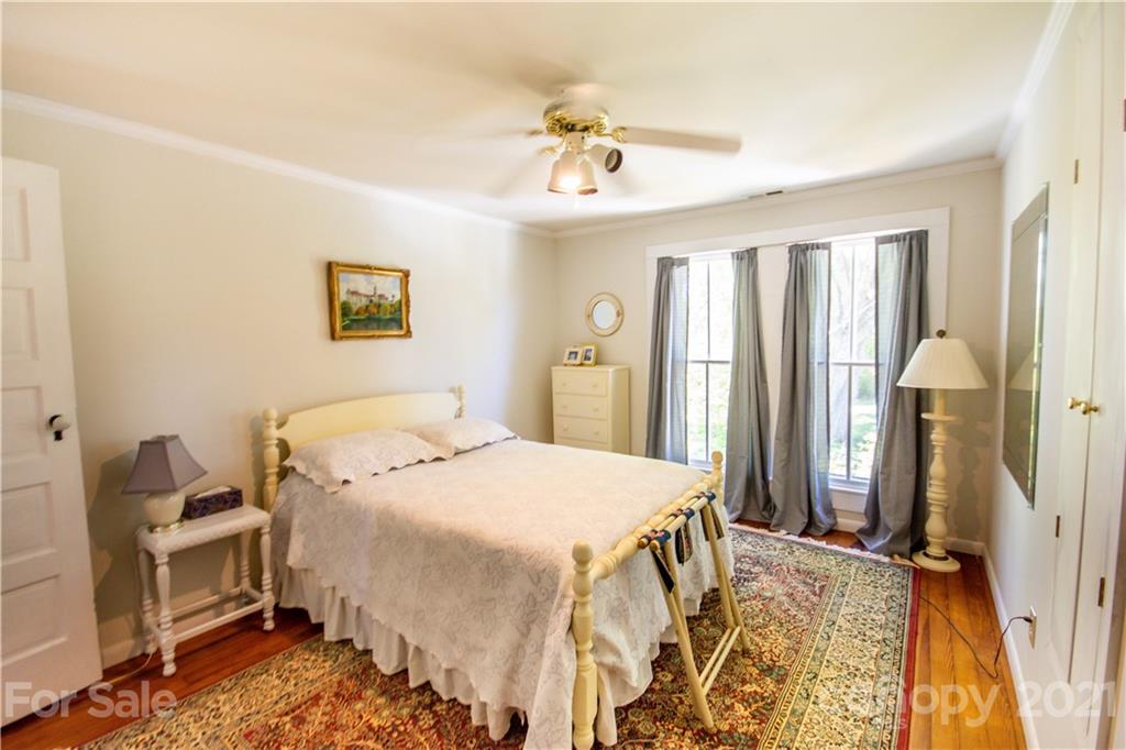 1870 Centenary Church Road Mount Ulla, NC 28125 - Photo 24 of 48 a spacious bedroom with a bed and a chandelier