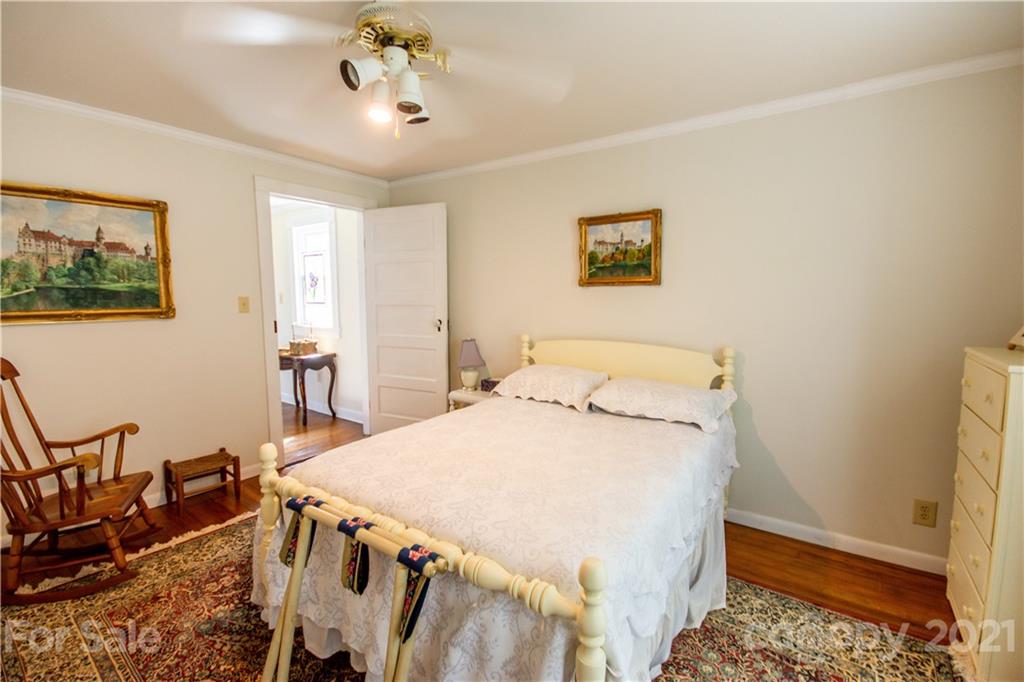 1870 Centenary Church Road Mount Ulla, NC 28125 - Photo 25 of 48 a bedroom with a bed and a chandelier