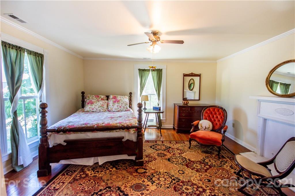 1870 Centenary Church Road Mount Ulla, NC 28125 - Photo 28 of 48 a bedroom with a bed chair and glass door