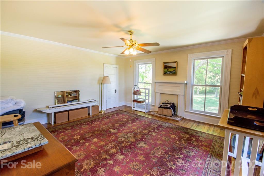 1870 Centenary Church Road Mount Ulla, NC 28125 - Photo 30 of 48 a living room with furniture a fireplace and a book shelf