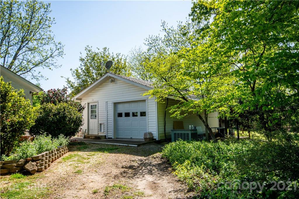 1870 Centenary Church Road Mount Ulla, NC 28125 - Photo 40 of 48 a front view of a house with a yard and garage