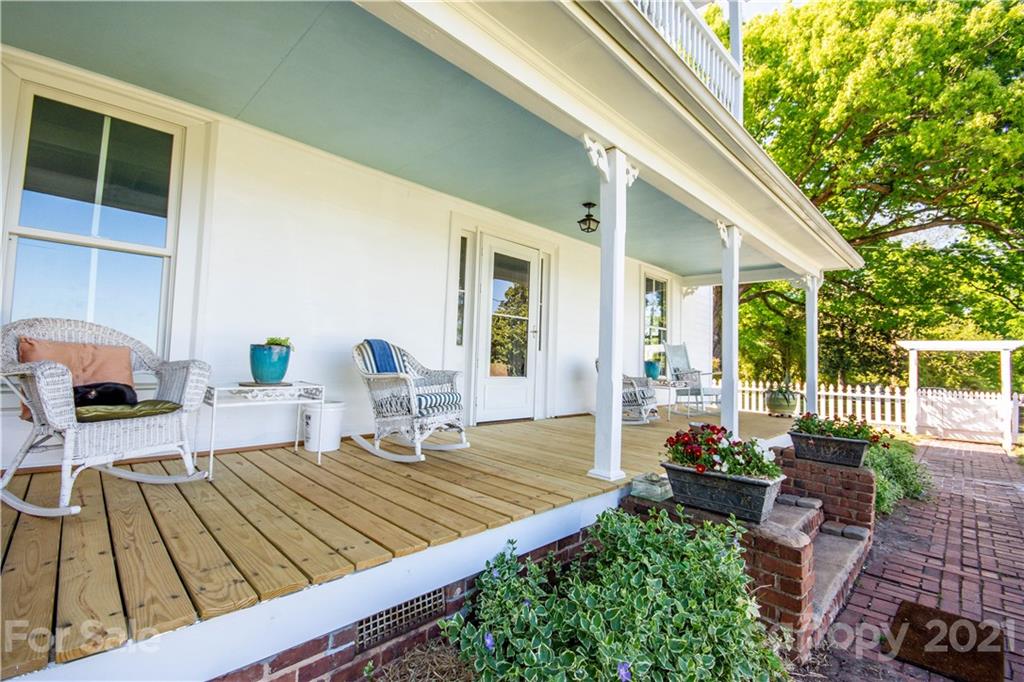 1870 Centenary Church Road Mount Ulla, NC 28125 - Photo 5 of 48 a view of a patio with couches chairs potted plants and wooden floor
