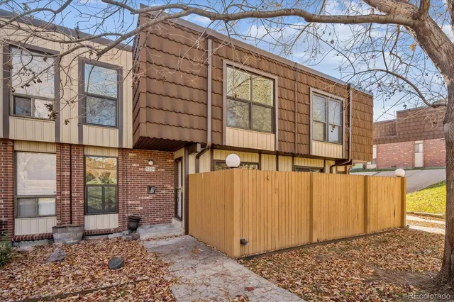 a view of a blue house with a large window