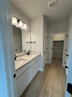 a bathroom with a double vanity sink and mirror