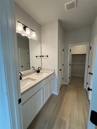 a bathroom with a double vanity sink and mirror
