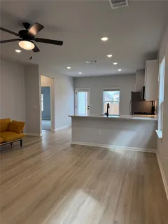 a view of a kitchen with a sink and a living room