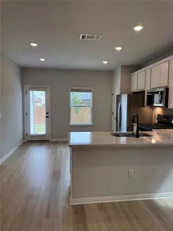 a view of a kitchen with a sink and a window