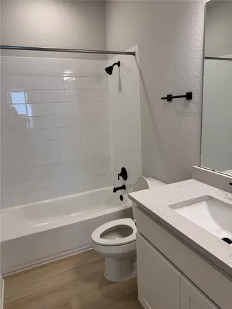 a bathroom with a sink a toilet and a bathtub