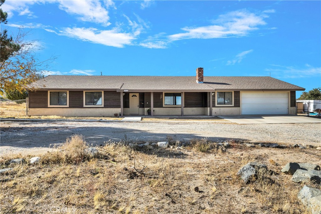 9930 Riggins Road Phelan, CA 92371 - Photo 1 of 1 a front view of a house with a yard