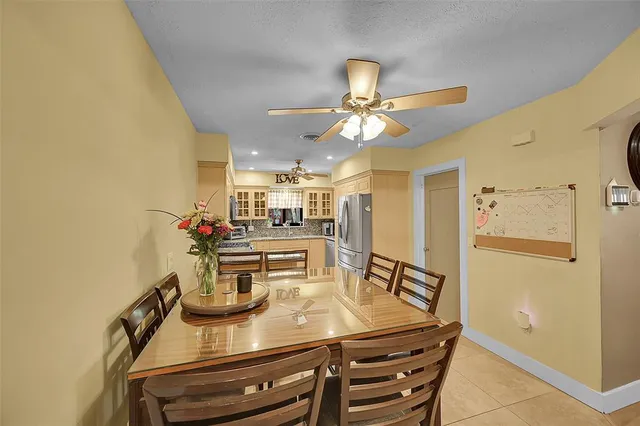 a view of a dining room with furniture and a chandelier