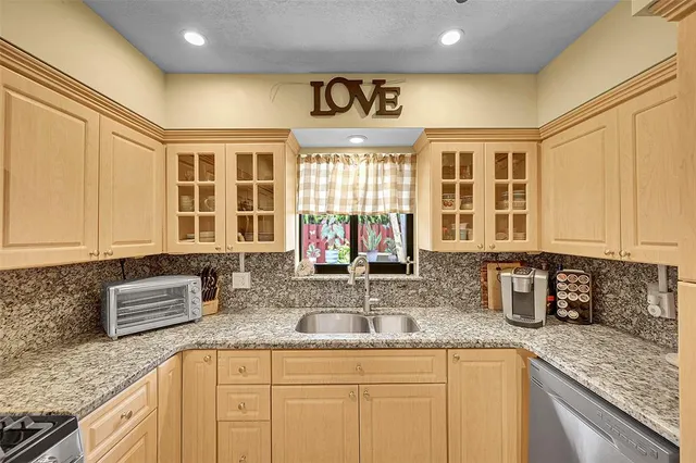 a kitchen with stainless steel appliances granite countertop a sink and a granite counter tops