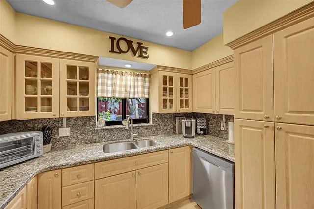a kitchen with stainless steel appliances granite countertop a sink and a granite counter tops