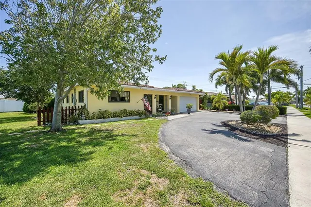 a front view of house with yard and green space
