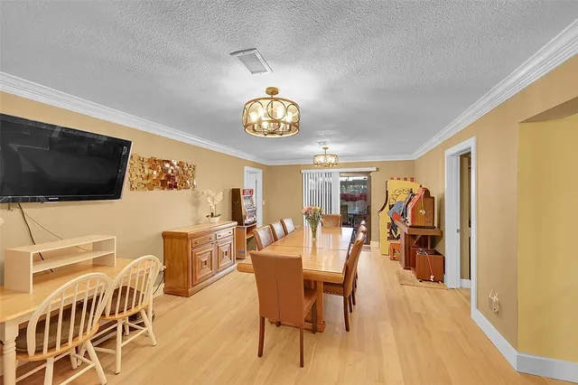 a view of a livingroom with furniture flat screen tv and wooden floor
