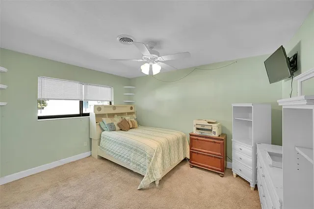 a bedroom with a bed dresser and a window