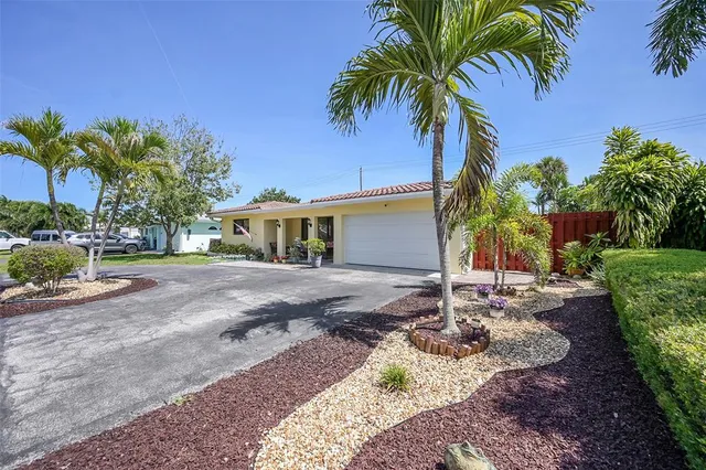 a view of a house with a yard and sitting area