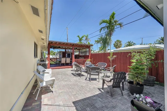a view of a patio with table and chairs potted plants