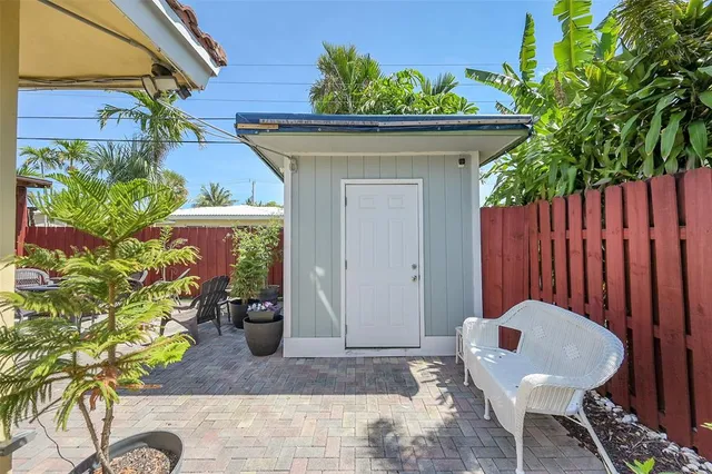 a view of a house with chair and potted plant