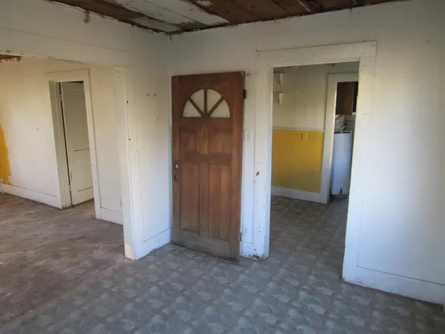 wooden floor in an empty room and a window