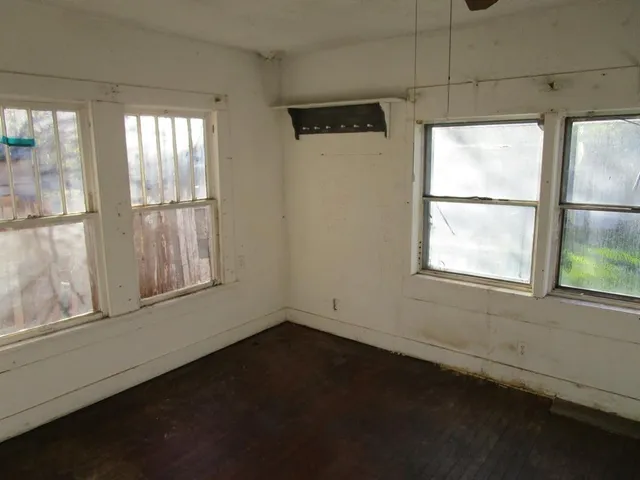 a room with wooden cabinets and a window