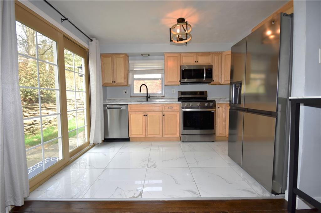 104 Earlwood Road Pittsburgh, PA 15235 - Photo 11 of 40 a kitchen with stainless steel appliances a refrigerator sink and microwave