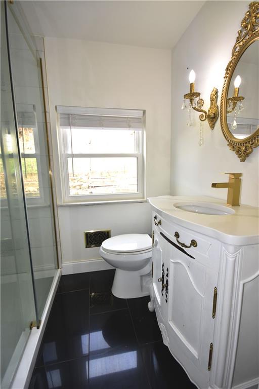 104 Earlwood Road Pittsburgh, PA 15235 - Photo 12 of 40 a bathroom with a sink a toilet and mirror