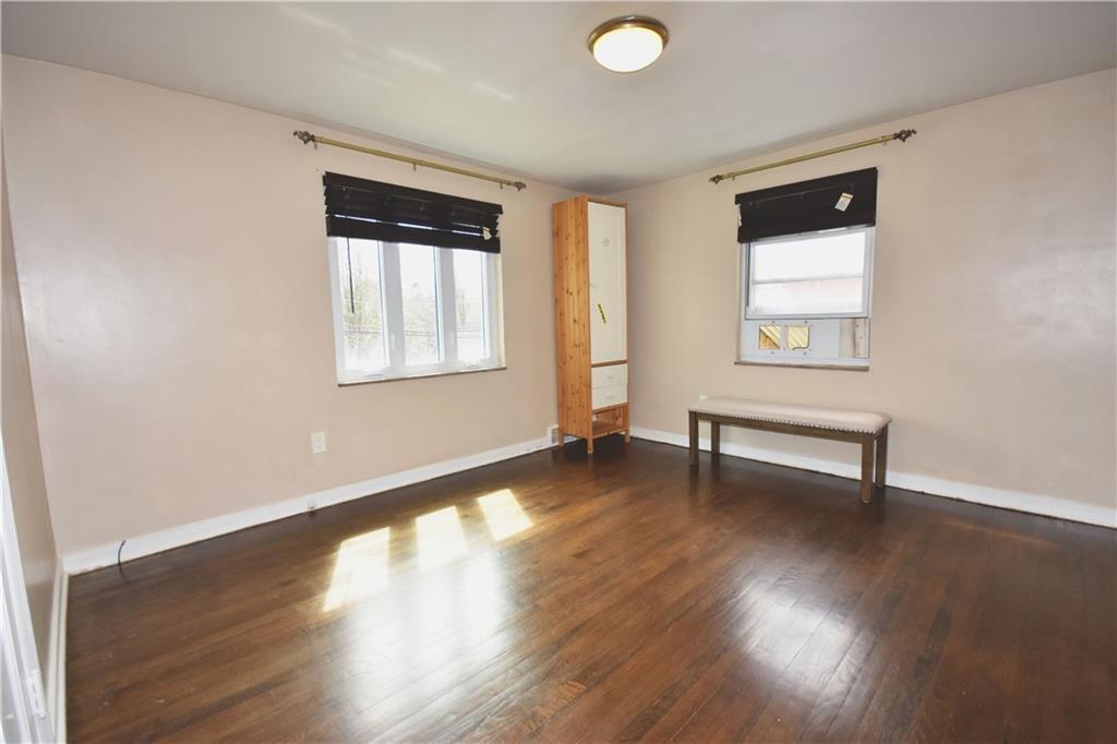 104 Earlwood Road Pittsburgh, PA 15235 - Photo 18 of 40 a view of an empty room with wooden floor and a window