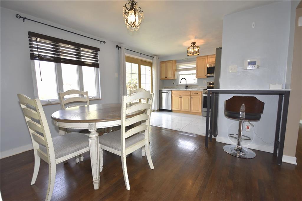 104 Earlwood Road Pittsburgh, PA 15235 - Photo 7 of 40 a dining room with furniture a chandelier and wooden floor