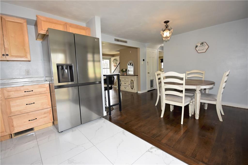 104 Earlwood Road Pittsburgh, PA 15235 - Photo 8 of 40 a kitchen with stainless steel appliances kitchen island granite countertop a table chairs and a refrigerator