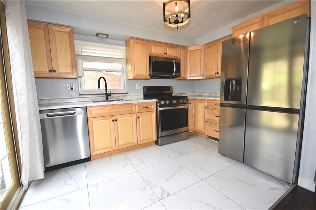104 Earlwood Road Pittsburgh, PA 15235 - Photo 9 of 40 a kitchen with stainless steel appliances granite countertop a refrigerator sink and stove