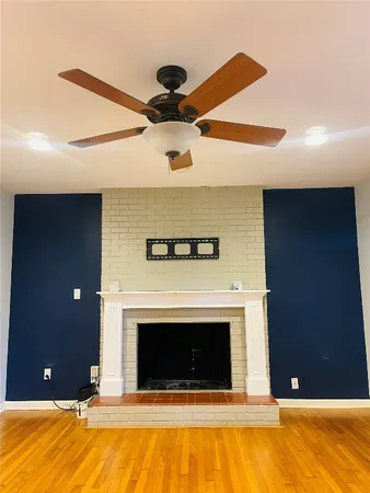 a view of a livingroom with a fireplace and fan