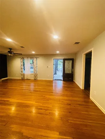 a view of empty room with wooden floor and fireplace
