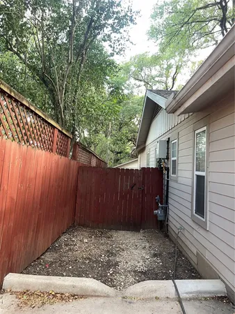 a view of a house with wooden deck and a trees