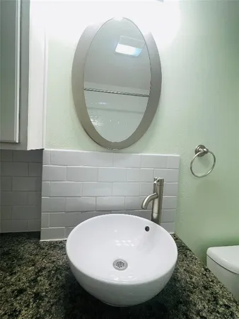 a bathroom with a sink a mirror and a toilet