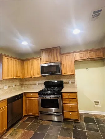 a kitchen with a stove a sink and a microwave