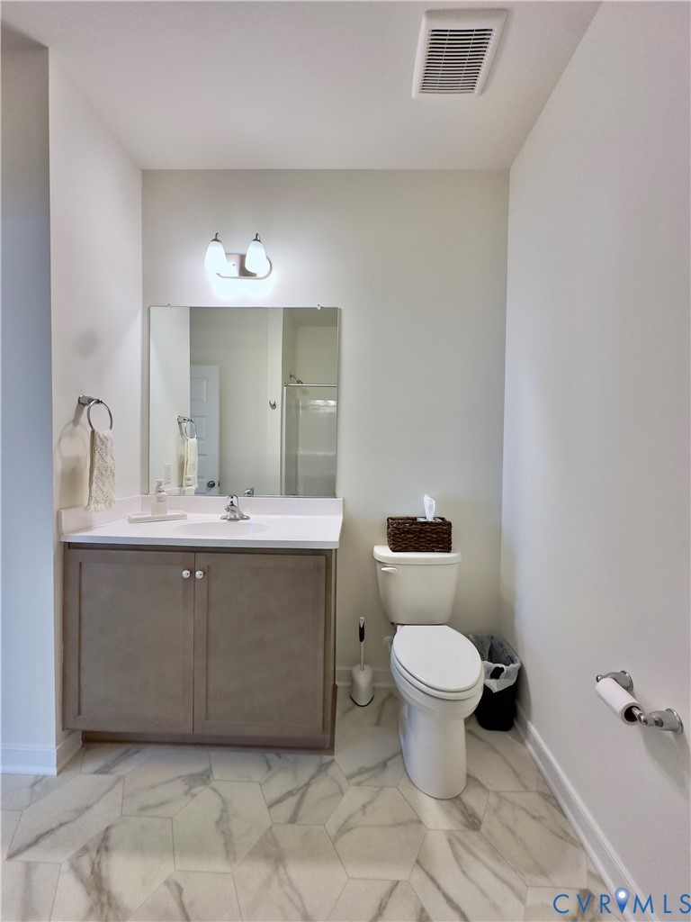 12423 Wescott Avenue Midlothian, VA 23112 - Photo 12 of 25 a bathroom with a toilet sink and mirror