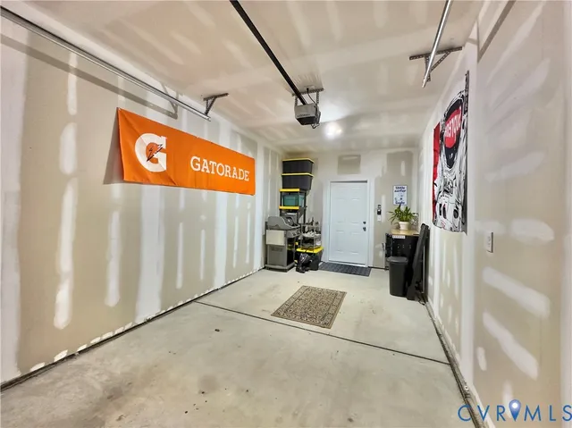 a kitchen with stainless steel appliances a dining table chairs refrigerator and microwave